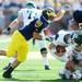 Michigan junior defensive end Craig Roh reaches after Eastern Michigan quarterback Alex Gillett during the third quarter against Eastern Michigan at Michigan Stadium on Saturday. Melanie Maxwell I AnnArbor.com
